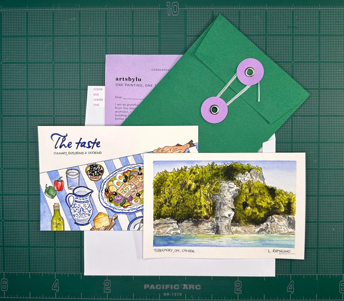 The Founding Edition mail club pack — watercolour print, The Taste recipe card, handmade green envelope and letter